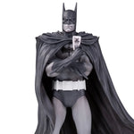 Close-up of Brian Bolland Batman Black and White statue holding Joker card